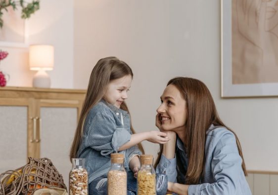 A loving mother and daughter enjoying quality time together in a cozy kitchen setting.