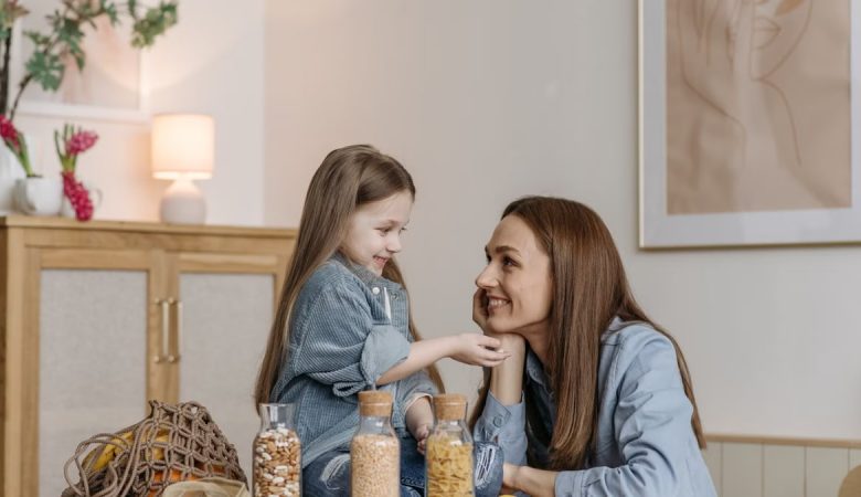A loving mother and daughter enjoying quality time together in a cozy kitchen setting.